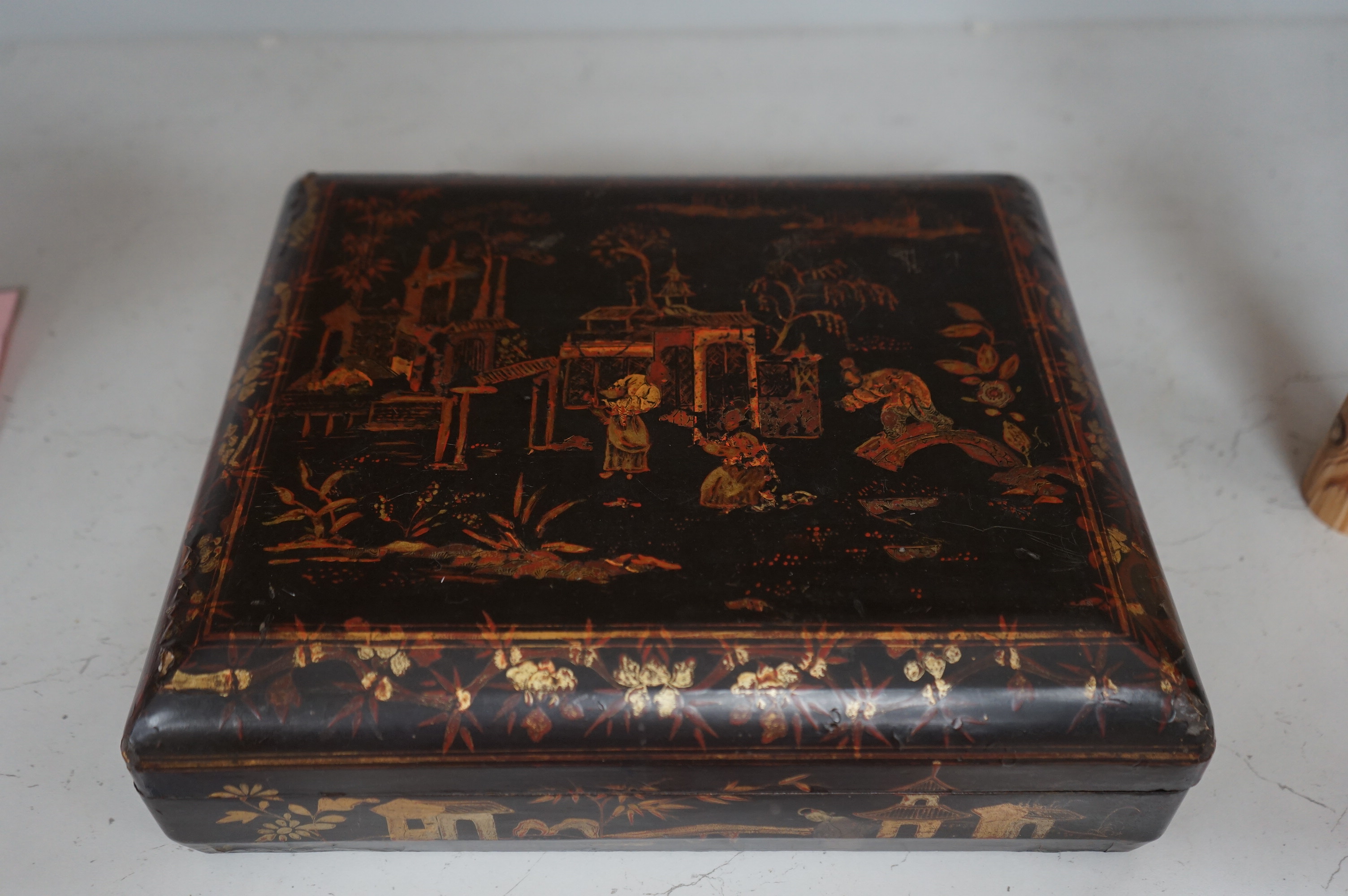 A mid 19th century Chinese gilt decorated black lacquer games box, 31cm wide. Condition - fair to good